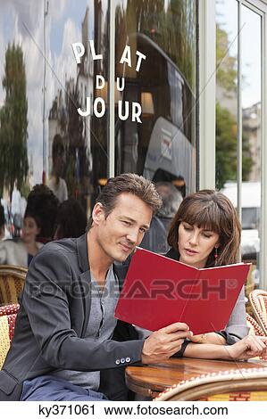 Couple reading menu at a restaurant, Paris, Ile-de-France, France View Large Photo Image Stock Image - Couple reading menu at a restaurant, Paris, Ile-de-France, France. Fotosearch