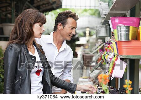 Couple shopping at a market stall, Paris, Ile-de-France, France View Large Photo Image Picture - Couple shopping at a market stall, Paris, Ile-de-France, France. Fotosearch