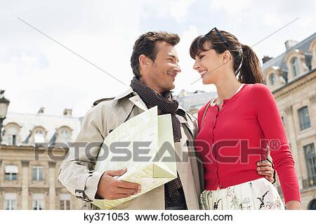 Low angle view of a couple smiling at each other, Paris, Ile-de-France, France View Large Photo Image Stock Image - Low angle view of a couple smiling at each other, Paris, Ile-de-France, France. Fotosearch