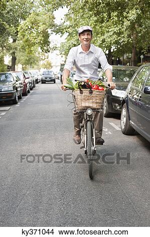 Man carrying vegetables on a bicycle, Paris, Ile-de-France, France View Large Photo Image Picture - Man carrying vegetables on a bicycle, Paris, Ile-de-France, France. Fotosearch