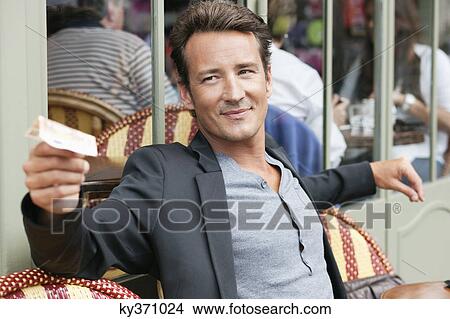 Man paying bill in a restaurant, Paris, Ile-de-France, France View Large Photo Image Picture - Man paying bill in a restaurant, Paris, Ile-de-France, France. Fotosearch