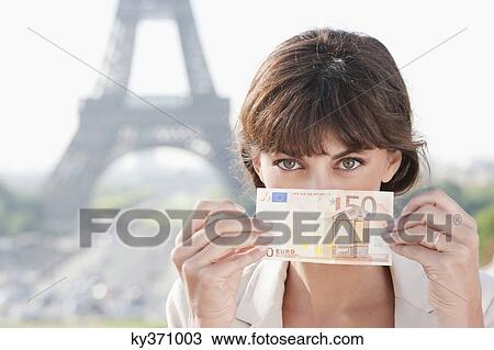 Woman showing 50 Euro banknote with the Eiffel Tower in the background, Paris, Ile-de-France, France View Large Photo Image Stock Image - Woman showing 50 Euro banknote with the Eiffel Tower in the background, Paris, Ile-de-France, France. Fotosearch