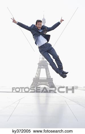 Businessman jumping with the Eiffel Tower in the background, Paris, Ile-de-France, France View Large Photo Image Stock Photography - Businessman jumping with the Eiffel Tower in the background, Paris, Ile-de-France, France. Fotosearch