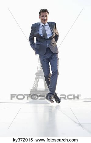 Stock Photography - Businessman jumping with the Eiffel Tower in the background, Paris, Ile-de-France, France. Fotosearch