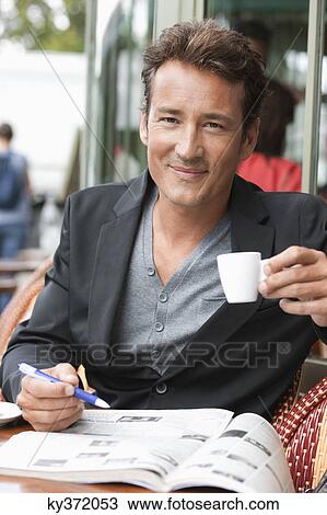 Man drinking coffee in a restaurant, Paris, Ile-de-France, France View Large Photo Image Stock Image - Man drinking coffee in a restaurant, Paris, Ile-de-France, France. Fotosearch
