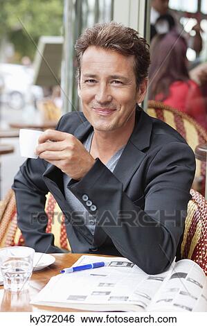 Man drinking coffee in a restaurant, Paris, Ile-de-France, France View Large Photo Image Stock Photograph - Man drinking coffee in a restaurant, Paris, Ile-de-France, France. Fotosearch