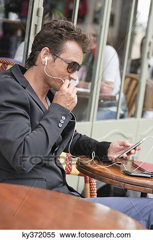 Man talking on a mobile phone in a restaurant, Paris, Ile-de-France, France View Large Photo Image Stock Photography - Man talking on a mobile phone in a restaurant, Paris, Ile-de-France, France. Fotosearch