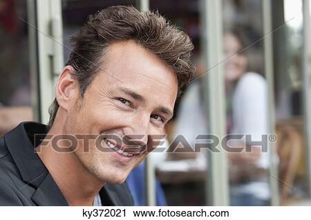 Stock Image - Portrait of a man smiling, Paris, Ile-de-France, France. Fotosearch