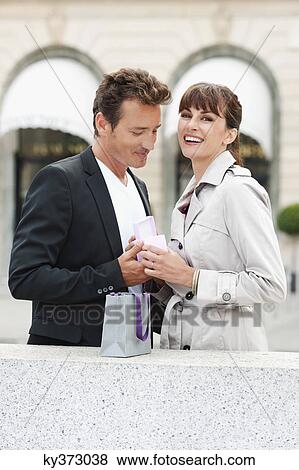 Stock Photo - Couple holding a gift, Paris, Ile-de-France, France. Fotosearch