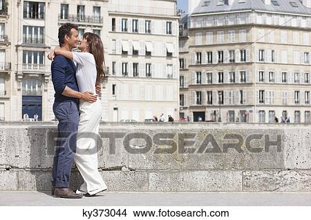 Couple kissing each other, Paris, Ile-de-France, France View Large Photo Image Picture - Couple kissing each other, Paris, Ile-de-France, France. Fotosearch