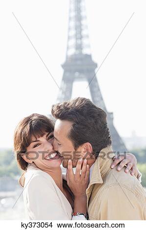Couple kissing with the Eiffel Tower in the background, Paris, Ile-de-France, France View Large Photo Image Picture - Couple kissing with the Eiffel Tower in the background, Paris, Ile-de-France, France. Fotosearch