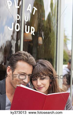 Couple reading menu at a restaurant, Paris, Ile-de-France, France View Large Photo Image Stock Image - Couple reading menu at a restaurant, Paris, Ile-de-France, France. Fotosearch