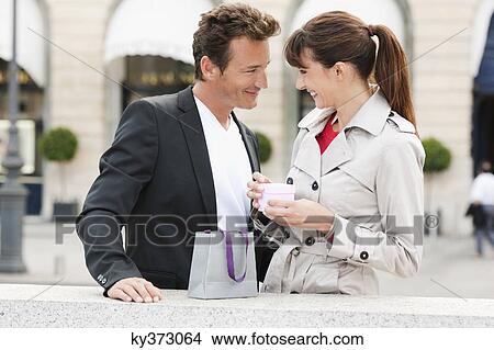 Picture - Couple smiling at each other, Paris, Ile-de-France, France. Fotosearch
