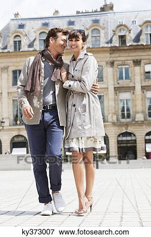 Stock Photo - Couple walking on a street, Paris, Ile-de-France, France. Fotosearch
