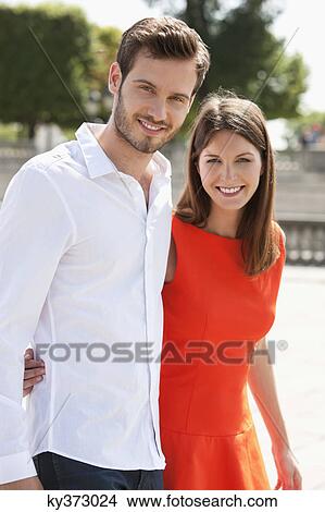 Couple walking with arms around and smiling, Paris, Ile-de-France, France View Large Photo Image Picture - Couple walking with arms around and smiling, Paris, Ile-de-France, France. Fotosearch