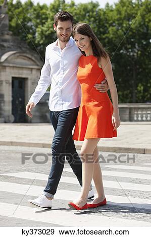 Couple walking with arms around and smiling, Paris, Ile-de-France, France View Large Photo Image Stock Photo - Couple walking with arms around and smiling, Paris, Ile-de-France, France. Fotosearch