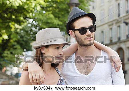 Stock Photo - Couple with arms around each other, Paris, Ile-de-France, France. Fotosearch