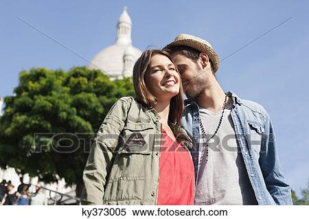Low angle view of a couple, Montmartre, Paris, Ile-de-France, France View Large Photo Image Stock Photography - Low angle view of a couple, Montmartre, Paris, Ile-de-France, France. Fotosearch