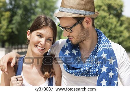 Man with his arm around a woman smiling, Paris, Ile-de-France, France View Large Photo Image Stock Photo - Man with his arm around a woman smiling, Paris, Ile-de-France, France. Fotosearch