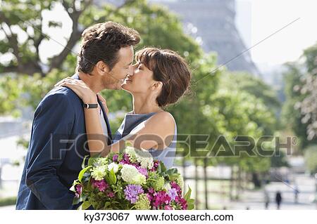 Romantic couple about to kiss with the Eiffel Tower in the background, Paris, Ile-de-France, France View Large Photo Image Stock Photo - Romantic couple about to kiss with the Eiffel Tower in the background, Paris, Ile-de-France, France. Fotosearch