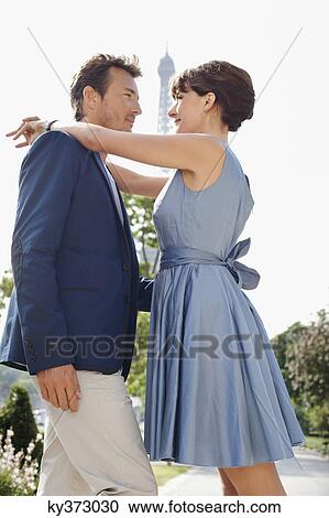 Romantic couple with the Eiffel Tower in the background, Paris, Ile-de-France, France View Large Photo Image Stock Image - Romantic couple with the Eiffel Tower in the background, Paris, Ile-de-France, France. Fotosearch