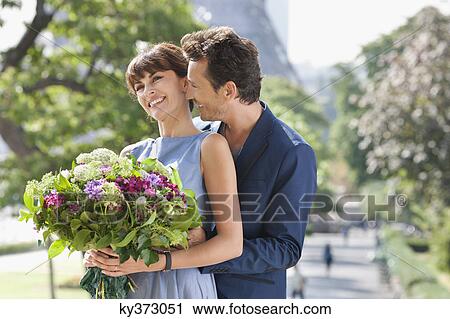 Romantic couple with the Eiffel Tower in the background, Paris, Ile-de-France, France View Large Photo Image Stock Image - Romantic couple with the Eiffel Tower in the background, Paris, Ile-de-France, France. Fotosearch