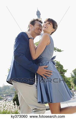 Romantic couple with the Eiffel Tower in the background, Paris, Ile-de-France, France View Large Photo Image Stock Image - Romantic couple with the Eiffel Tower in the background, Paris, Ile-de-France, France. Fotosearch