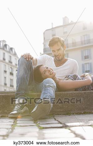 Woman lying on lap of a man at the ledge of a canal, Paris, Ile-de-France, France View Large Photo Image Picture - Woman lying on lap of a man at the ledge of a canal, Paris, Ile-de-France, France. Fotosearch