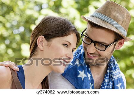 Stock Image - Close-up of a couple smiling, Paris, Ile-de-France, France. Fotosearch