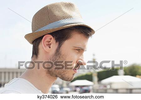 Stock Photograph - Close-up of a man wearing a hat, Paris, Ile-de-France, France. Fotosearch