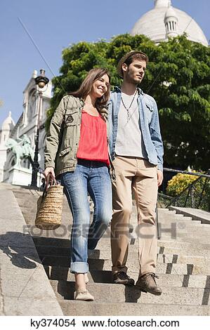 Picture - Couple moving down staircases, Montmartre, Paris, Ile-de-France, France. Fotosearch