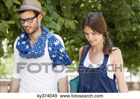 Couple walking together and smiling, Paris, Ile-de-France, France View Large Photo Image Stock Photo - Couple walking together and smiling, Paris, Ile-de-France, France. Fotosearch