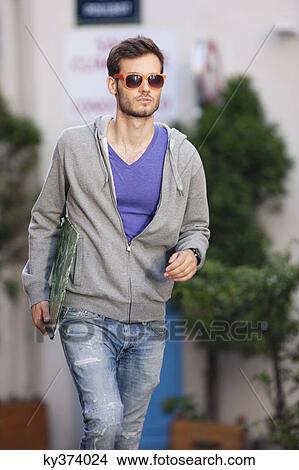 Picture - Man carrying a file, Paris, Ile-de-France, France. Fotosearch
