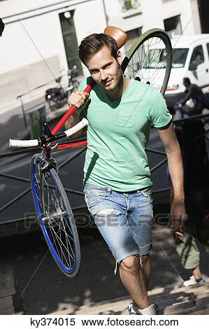 Man carrying a sports bicycle on his shoulders, Paris, Ile-de-France, France View Large Photo Image Stock Photography - Man carrying a sports bicycle on his shoulders, Paris, Ile-de-France, France. Fotosearch