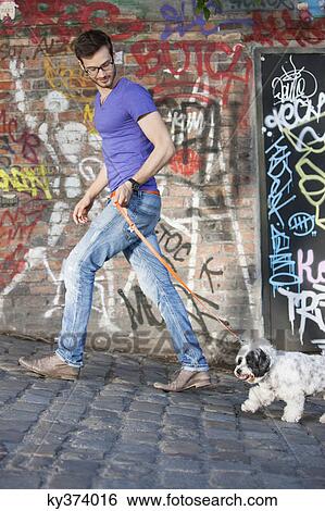 Man holding a dog on leash, Paris, Ile-de-France, France View Large Photo Image Stock Photograph - Man holding a dog on leash, Paris, Ile-de-France, France. Fotosearch