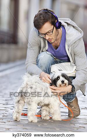 Man opening the leash of a dog, Paris, Ile-de-France, France View Large Photo Image Stock Photo - Man opening the leash of a dog, Paris, Ile-de-France, France. Fotosearch