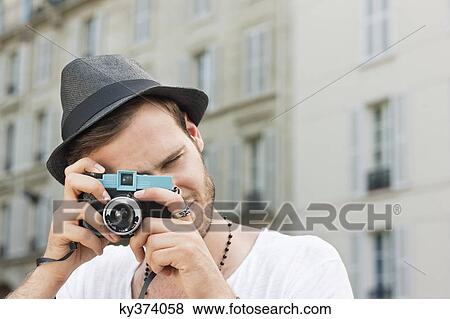 Man photographing with a camera, Paris, Ile-de-France, France View Large Photo Image Stock Photo - Man photographing with a camera, Paris, Ile-de-France, France. Fotosearch