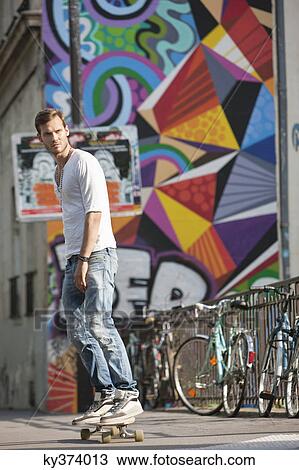 Stock Image - Man skateboarding on the road, Paris, Ile-de-France, France. Fotosearch