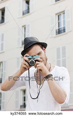 Man taking a picture with a camera, Paris, Ile-de-France, France View Large Photo Image Stock Photography - Man taking a picture with a camera, Paris, Ile-de-France, France. Fotosearch