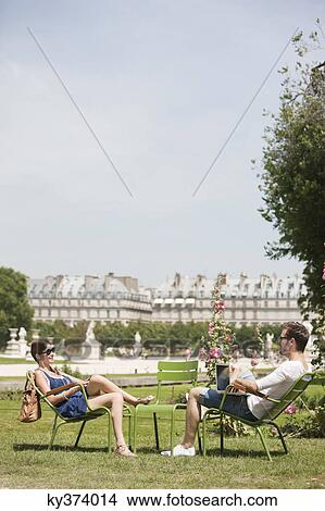 Man using a laptop with a woman sitting in front of him, Jardin des Tuileries, Paris, Ile-de-France, France View Large Photo Image Picture - Man using a laptop with a woman sitting in front of him, Jardin des Tuileries, Paris, Ile-de-France, France. Fotosearch