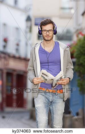 Man walking on the street with a newspaper, Paris, Ile-de-France, France View Large Photo Image Stock Image - Man walking on the street with a newspaper, Paris, Ile-de-France, France. Fotosearch