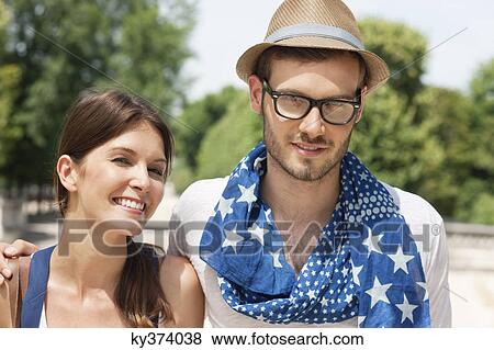 Man with his arm around a woman smiling, Paris, Ile-de-France, France View Large Photo Image Stock Photo - Man with his arm around a woman smiling, Paris, Ile-de-France, France. Fotosearch