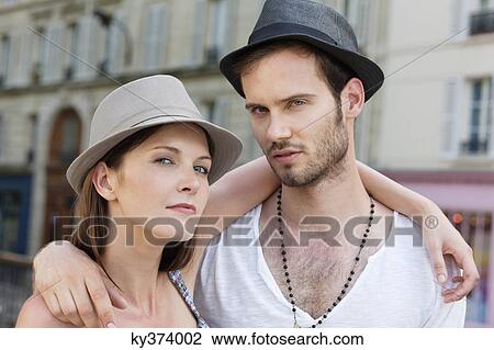 Portrait of a couple with their arm around each other, Paris, Ile-de-France, France View Large Photo Image Stock Image - Portrait of a couple with their arm around each other, Paris, Ile-de-France, France. Fotosearch