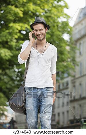 Portrait of a man talking on a mobile phone, Paris, Ile-de-France, France View Large Photo Image Stock Image - Portrait of a man talking on a mobile phone, Paris, Ile-de-France, France. Fotosearch