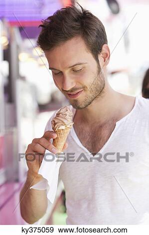 Close-up of a man eating ice cream, Paris, Ile-de-France, France View Large Photo Image Stock Photo - Close-up of a man eating ice cream, Paris, Ile-de-France, France. Fotosearch