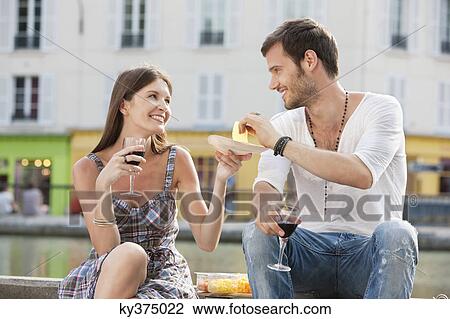 Stock Image - Couple drinking red wine, Paris, Ile-de-France, France. Fotosearch