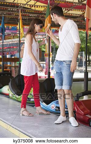 Stock Photo - Couple in an amusement park, Paris, Ile-de-France, France. Fotosearch