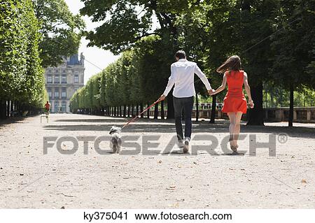 Couple running in a garden with a puppy, Terrasse De l'Orangerie, Jardin des Tuileries, Paris, Ile-de-France, France View Large Photo Image Stock Image - Couple running in a garden with a puppy, Terrasse De l'Orangerie, Jardin des Tuileries, Paris, Ile-de-France, France. Fotosearch