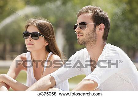Couple sitting in a garden, Bassin octogonal, Jardin des Tuileries, Paris, Ile-de-France, France View Large Photo Image Stock Photo - Couple sitting in a garden, Bassin octogonal, Jardin des Tuileries, Paris, Ile-de-France, France. Fotosearch