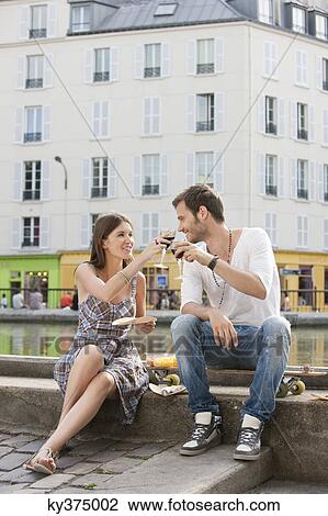 Couple toasting with wineglasses, Paris, Ile-de-France, France View Large Photo Image Stock Image - Couple toasting with wineglasses, Paris, Ile-de-France, France. Fotosearch